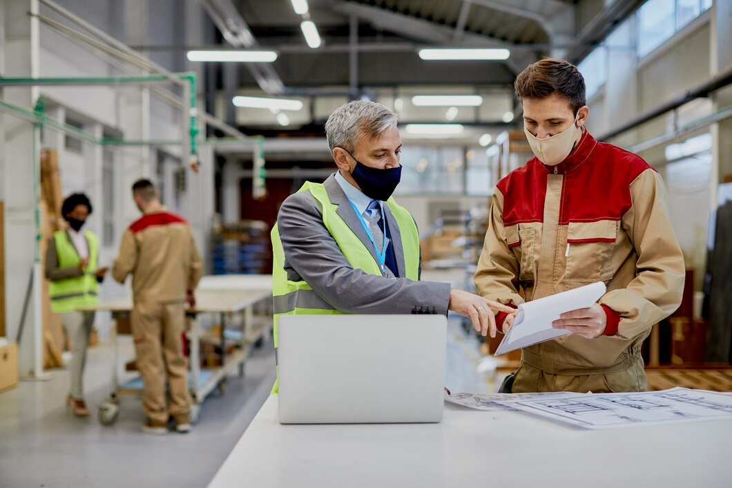 mid-adult-engineer-male-worker-wearing-face-masks-while-examining-paperwork-woodworking-factory_637285-11899